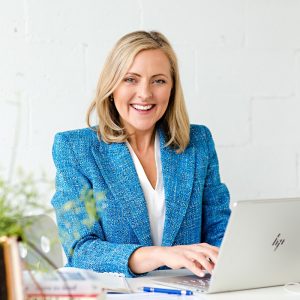 Wendy Cole Sitting at Desk with laptop being productive